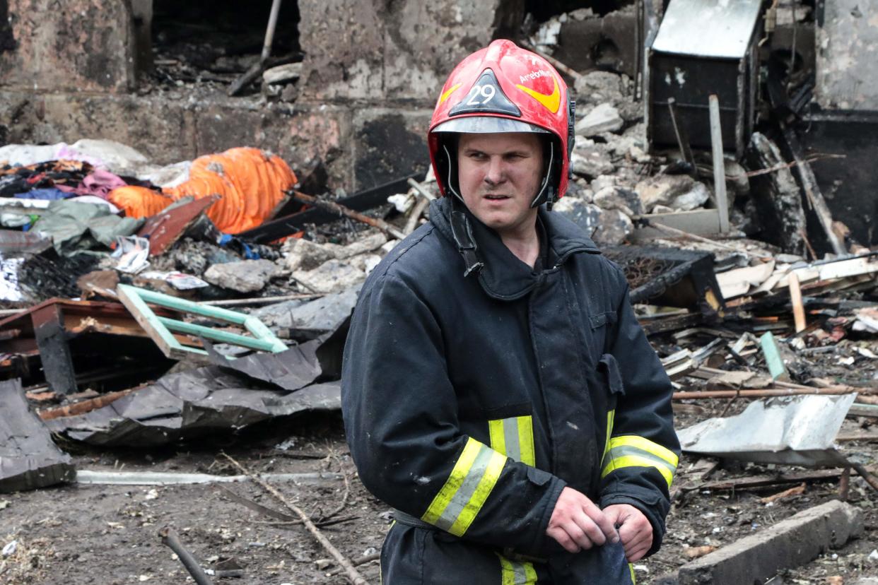 A firefighter stands in front of a destroyed five-storey residential building, following a Russian strike, in the city of Kryvyi Rig (AFP via Getty Images)