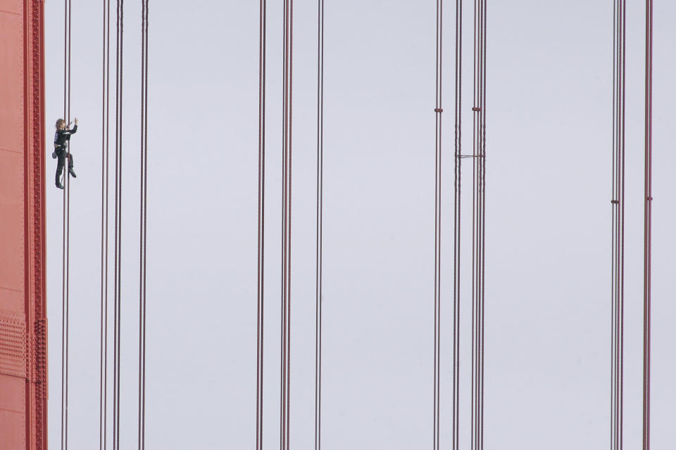 French daredevil climber Alain Robert, known as "Spiderman", climbs up the April 25 bridge over the Tagus river in Lisbon August 6, 2007. Robert, 44, completed the 190 metre climb during rush hour on Monday before giving himself up. REUTERS/Marcos Borga