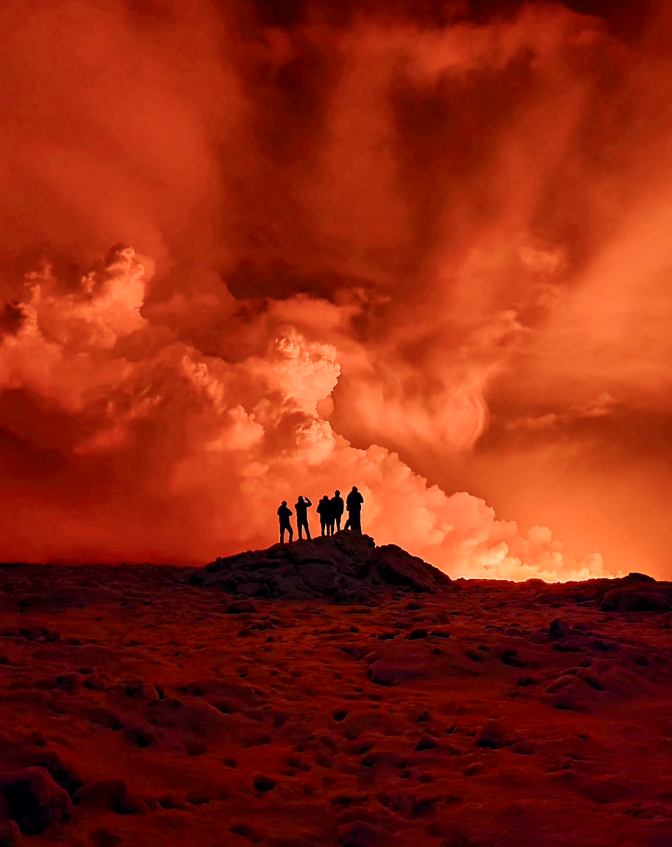 Local residents watch smoke billow from the volcano. (AFP via Getty Images)