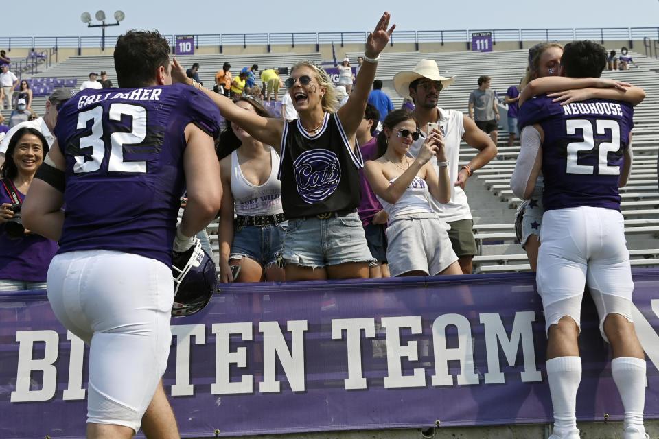 Northwestern linebacker Bryce Gallagher (32) is greeted by a fan after an NCAA college football game against Indiana State in Evanston, Ill., Saturday, Sept. 11, 2021. (AP Photo/Matt Marton)