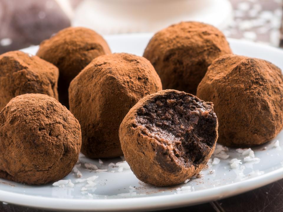 dark chocolate truffles on a white plate