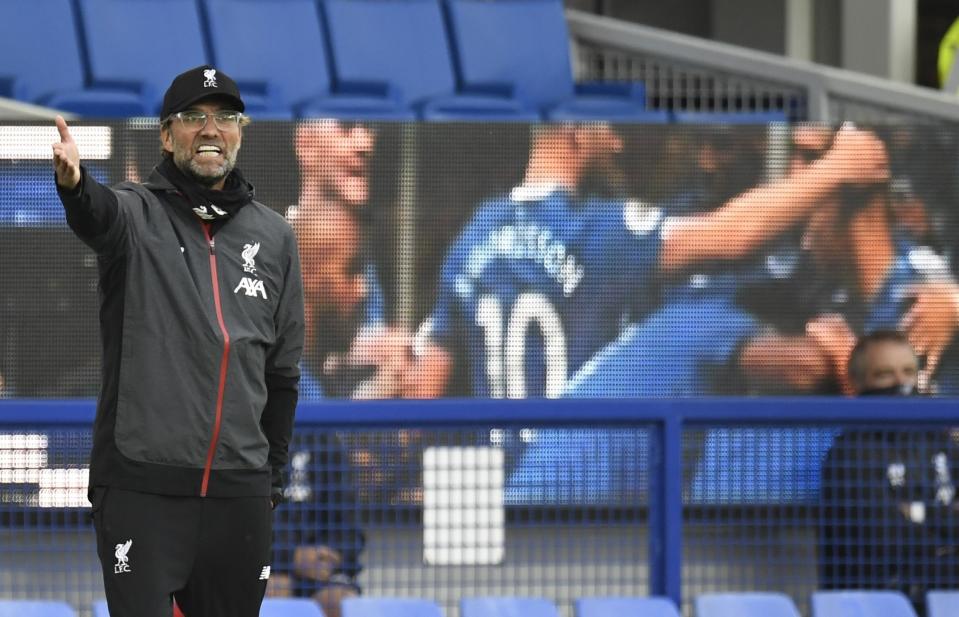 Liverpool's manager Jurgen Klopp shouts during the English Premier League soccer match between Everton and Liverpool at Goodison Park in Liverpool, England, Sunday, June 21, 2020. (Peter Powell/Pool via AP)