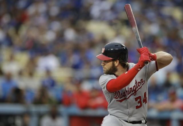 A Washington Nationals fan wears a Bryce Harper jersey before a baseball  game between the Washington Nationals and the Atlanta Braves, Thursday,  July 6, 2017, in Washington. Harper, Mike Trout and Aaron