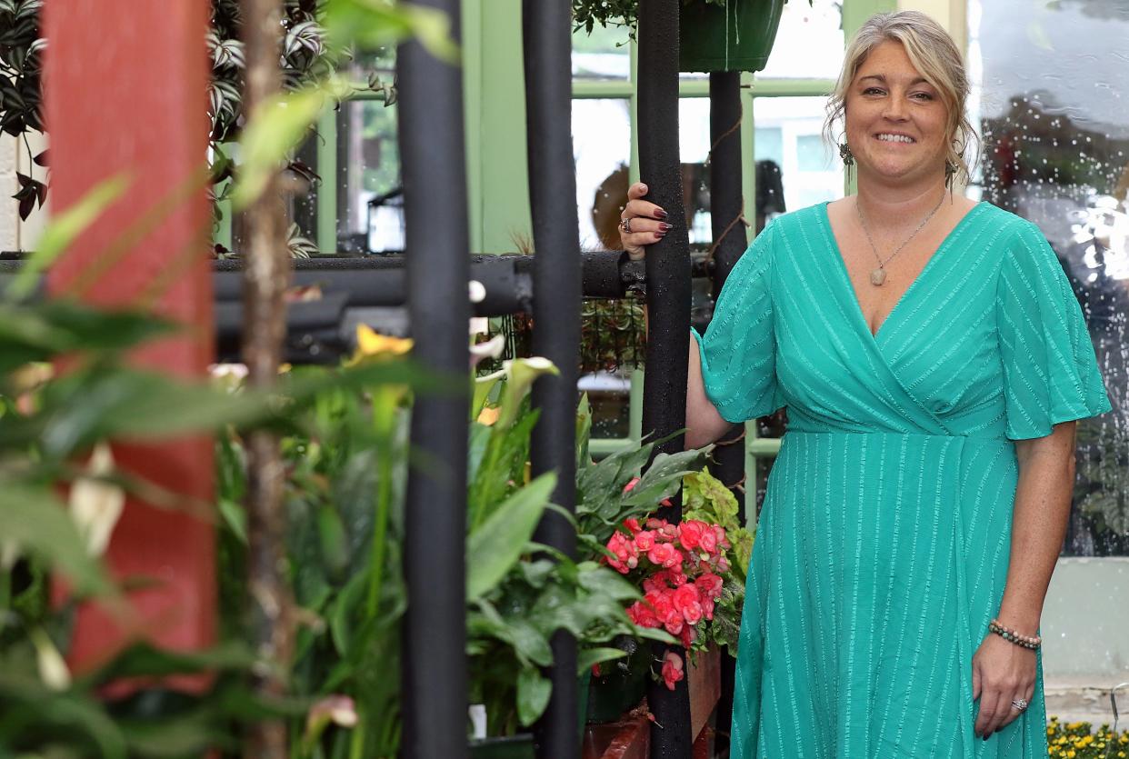 Lauren Dawsey-Smith stands in the greenhouse of her shop, Wild and Whimsey, Friday morning, Sept. 22, 2023, on Main Avenue in Gastonia.