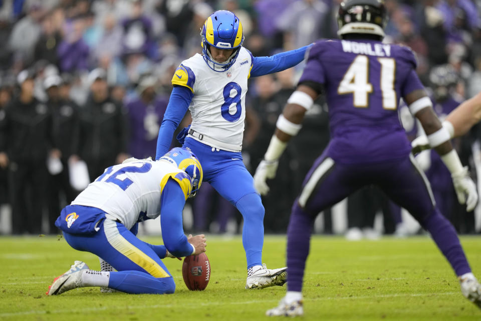 Los Angeles Rams place kicker Lucas Havrisik (8) kicks a field goal with the help of Rams holder Ethan Evans as Baltimore Ravens cornerback Daryl Worley (41) looks on during the first half of an NFL football game Sunday, Dec. 10, 2023, in Baltimore. (AP Photo/Alex Brandon)