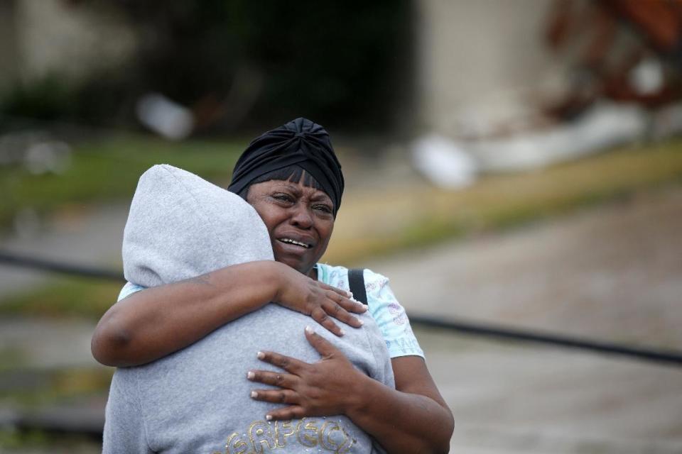 Lisa Carruth hugs her granddaughter Juayonna Carruth after a tornado tore through the eastern part of New Orleans, Tuesday, Feb. 7, 2017. The National Weather Service says at least three confirmed tornadoes have touched down, including one inside the New Orleans city limits. Buildings have been damaged and power lines are down. (AP Photo/Gerald Herbert)