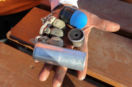 A protester named Benji Buffalo displays his collection of weapons used by police against protesters from a confrontation on Sunday during a protest against plans to pass the Dakota Access pipeline near the Standing Rock Indian Reservation, near Cannon Ball, North Dakota, U.S. November 22, 2016. REUTERS/Stephanie Keith