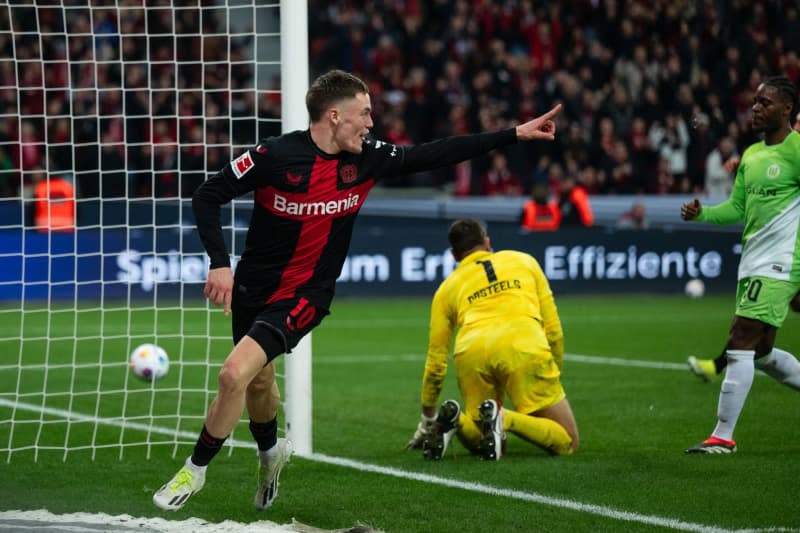 Leverkusen's Florian Wirtz celebrates scoring his side's second goal during the German Bundesliga soccer match between Bayer Leverkusen and VfL Wolfsburg at BayArena. Marius Becker/dpa