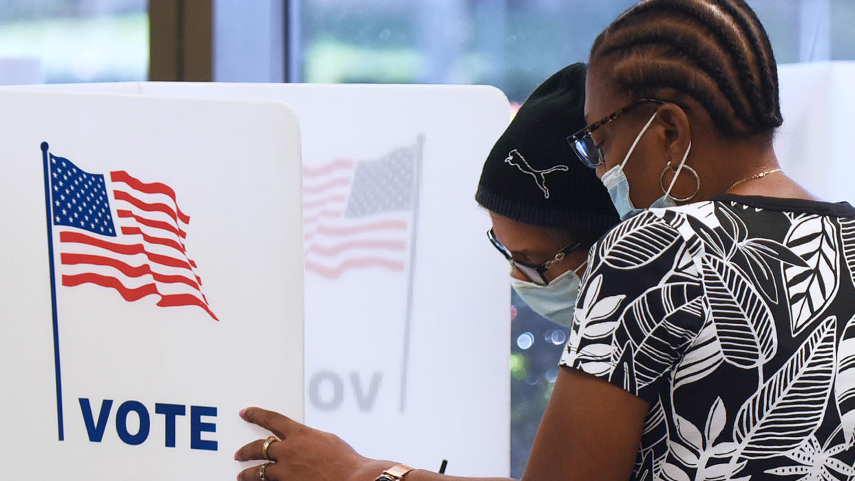  Two people cast their vote in the 2020 presidential election. 