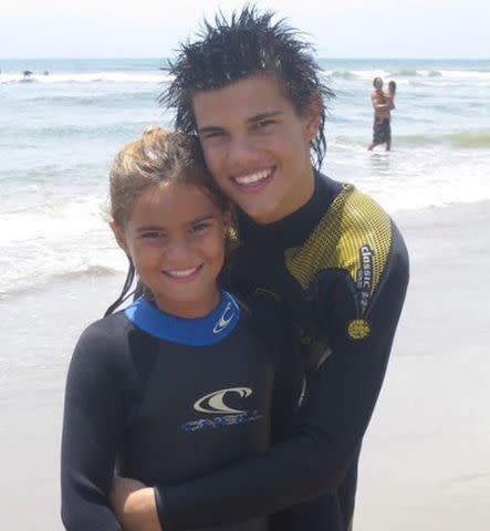 <p>Makena Moore Instagram</p> Taylor Lautner and his sister Makena Moore pose for a photo on a beach