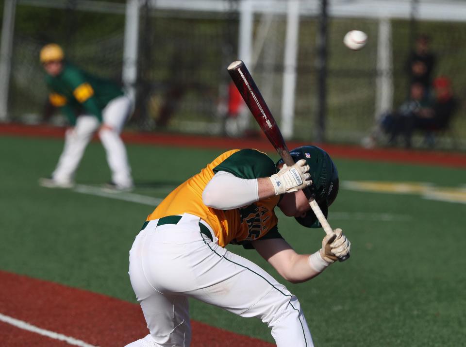 St. X's Cooper Smith (3) took first base after ducking a pitch from Trinity at the St. X High School in Louisville, Ky. on April 27, 2022.  St. X won 8-2.