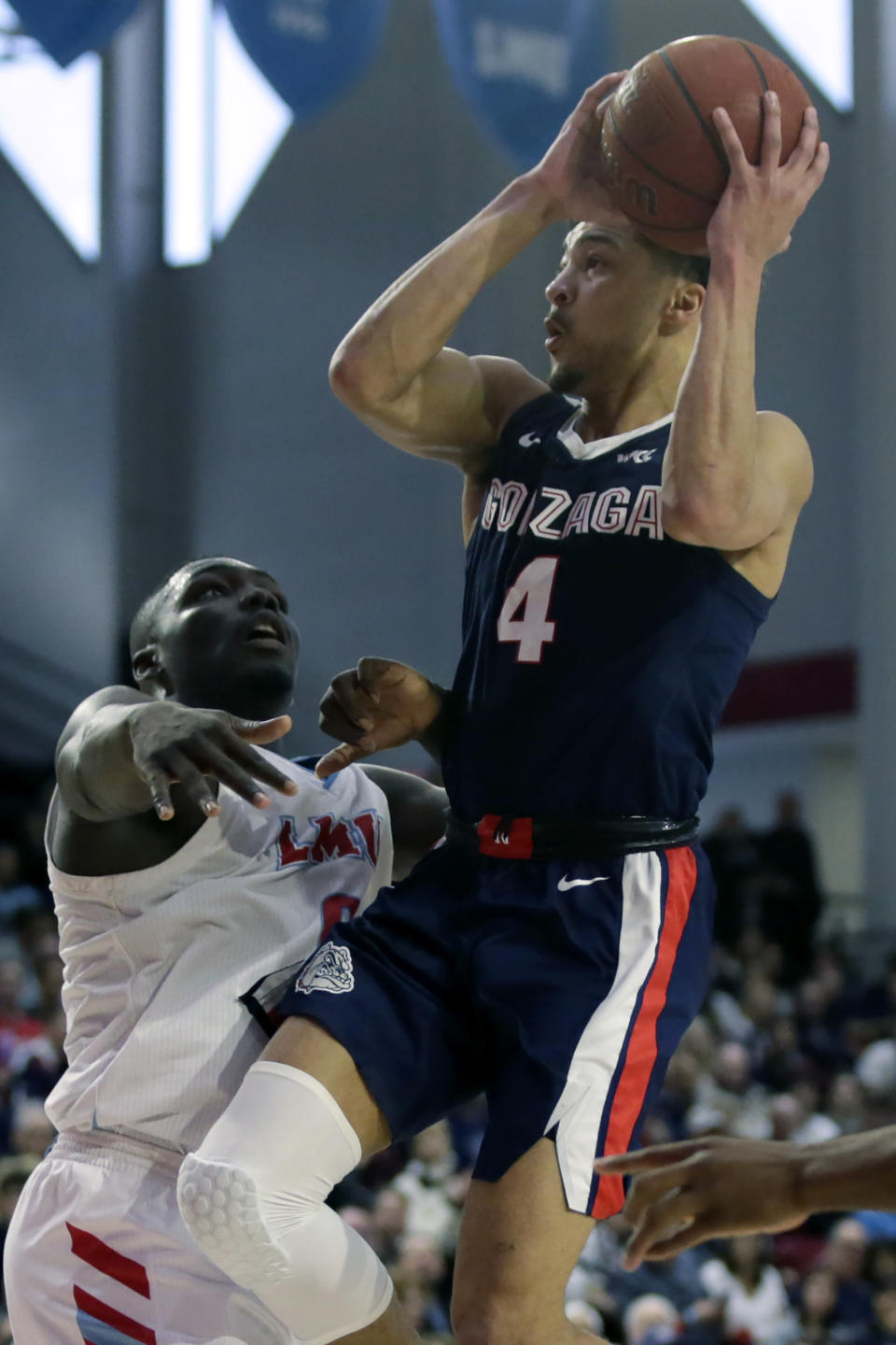 Gonzaga guard Ryan Woolridge, right, shoots over Loyola Marymount guard Eli Scott, left, during the second half of an NCAA college basketball game in Los Angeles, Saturday, Jan. 11, 2020. (AP Photo/Alex Gallardo)