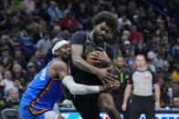 Oklahoma City Thunder guard Shai Gilgeous-Alexander defends as New Orleans Pelicans forward Naji Marshall drives to the basket in the first half of Game 4 of an NBA basketball first-round playoff series in New Orleans, Monday, April 29, 2024. (AP Photo/Gerald Herbert)