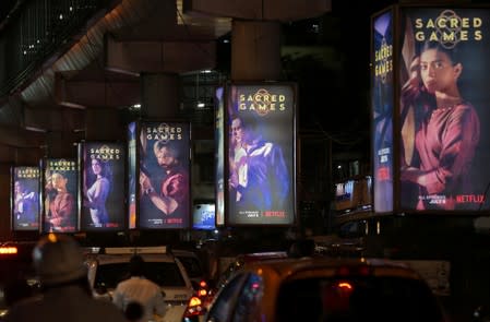 FILE PHOTO: Traffic moves on a road past hoardings of Netflix's new television series "Sacred Games" in Mumbai