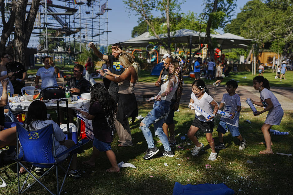 Children joke around as they spend the day during Israel's Independence Day celebrations, at a park, in Tel Aviv, Tuesday, May 14, 2024. Israelis are marking 76 years since Israel's creation. (AP Photo/Ohad Zwigenberg)