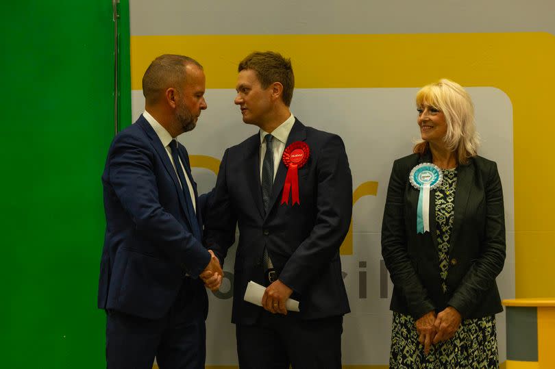 Conservative candidate James Daly congratulates Mr Frith after the result is announced