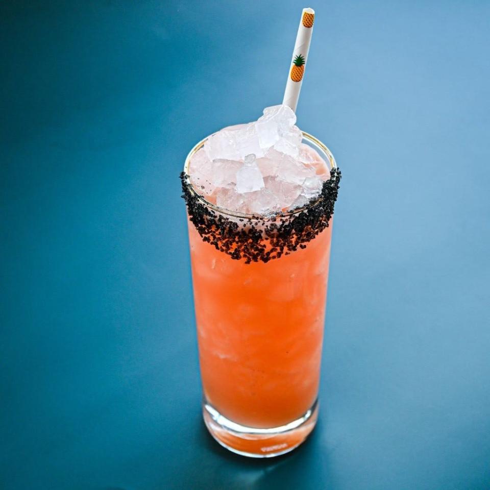 The Golden Pineapple’s 5 Star Island summer cocktail is made with blanco tequila, grapefruit, Aperol, watermelon, toasted coconut and pastis and served with a black salt rim.