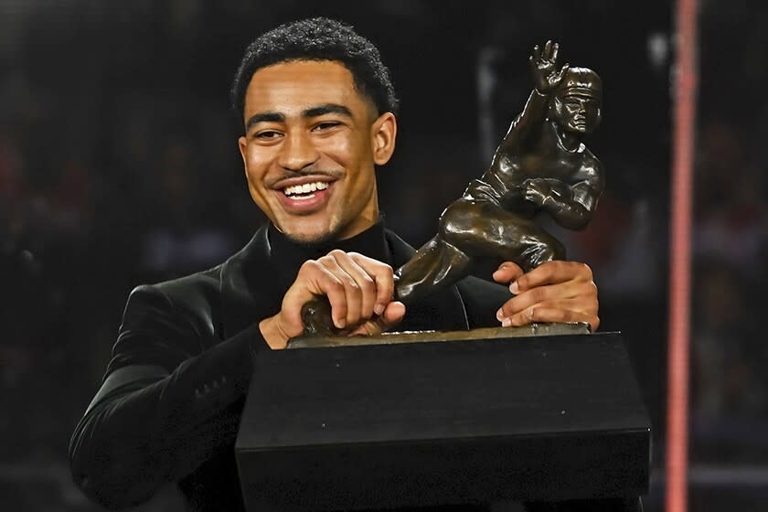 Alabama quarterback Bryce Young with his Heisman Trophy