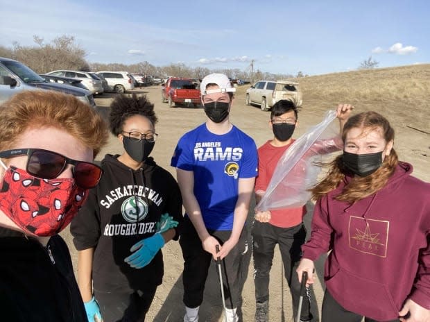 Sophia Lacroix (second from the left) and Kai Chen (second from the right) are seen this spring gathering plastic bottles with friends. The pair started SK Eco Solutions, a non-profit they hope will provide the raw material needed by 3D printers.  (Submitted by Kai Chen  - image credit)