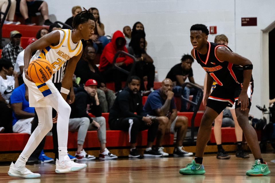 Newberry Panthers Juwan Scippio (24) and Hawthorne Hornets CJ Ingram (1) during the Class 1A-District 6 final basketball game between Newberry High School and Hawthorne High School at Fort White High School in Fort White, FL on Saturday, February 10, 2024. [Chris Watkins/Gainesville Sun]