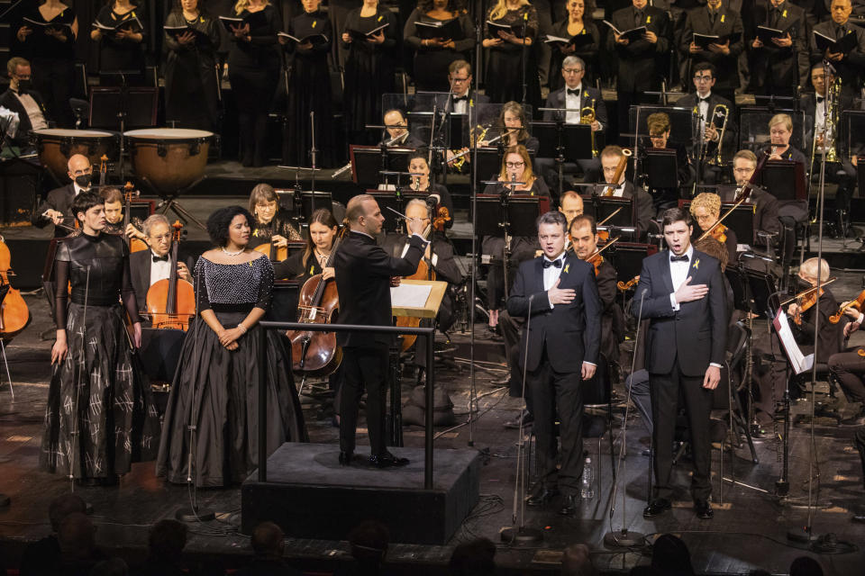 This photo provided by Metropolitan Opera, Met music director Yannick Nézet-Séguin leads mezzo-soprano Emily D’Angelo, soprano Golda Schultz, tenor Dmytro Popov, and bass-baritone Vladyslav Buialskyi in the National Anthem of Ukraine during "For Ukraine: A Concert of Remembrance and Hope" on Friday, Feb. 24, 2023 in New York. (Evan Zimmerman/Metropolitan Opera via AP)