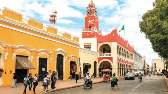 MERIDA, MEXICO - march 11, 2012: Day view of Municipal Palace (Palacio Municipal) with clock tower and street with people in Merida, Yucatan, Mexico