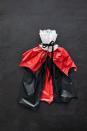 <p>No one will ever believe this costume is made from plastic tablecloths! </p><p><strong>For the cape: </strong></p><ul><li>Lay red and black plastic tablecloths on top of each other. </li><li>Trim both to fit your height (you want about 18” extra to fold over the top).</li><li>Cut a scallop edge along the top and bottom sides. </li><li>Lay a piece of black ribbon about 18” from the top of the tablecloths. </li><li>Fold the tablecloths over the ribbon and tie around your neck.</li><li>Fluff the tablecloths as needed. </li></ul><p><strong>For the collar: </strong></p><ul><li>Cut a 2” thick strip of printer paper to comfortably fit around your neck. </li><li>Accordion fold rectangle doilies and large round doilies cut in half. Attach to the paper strip with a glue stick or double-sided tape. </li><li>Glue a ribbon around the paper strip to fasten around the neck.</li></ul>