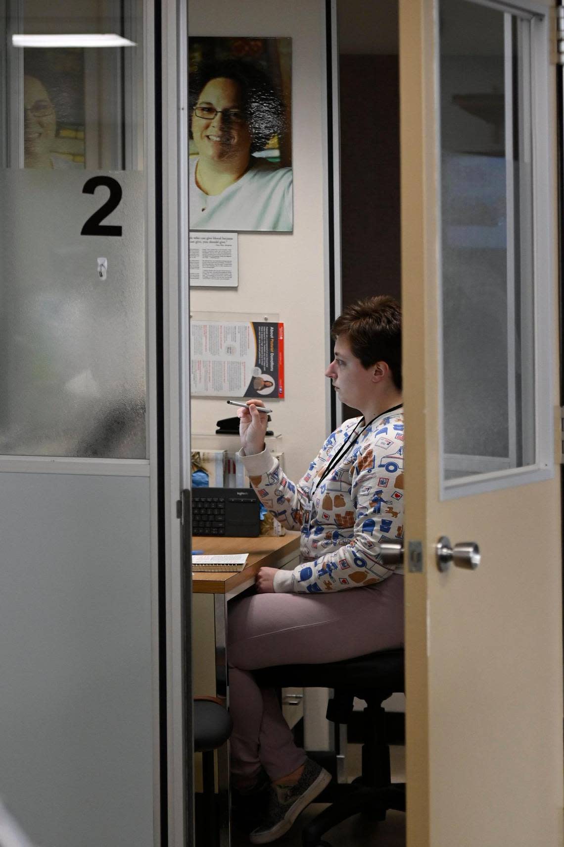 Wallington fills out a health questionnaire while being screened to donate blood at the Community Blood Center.