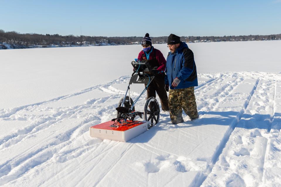 Miranda Washinawatok, a Menominee Nation member and a work study student at the Wisconsin Historical Society, is joined by William Quackenbus, the Ho-Chunk Nation tribal historic preservation officer, as the two use a ground penetrating radar on frozen Lake Mendota in early 2023. They were surveying the lakebed for additional artifacts.