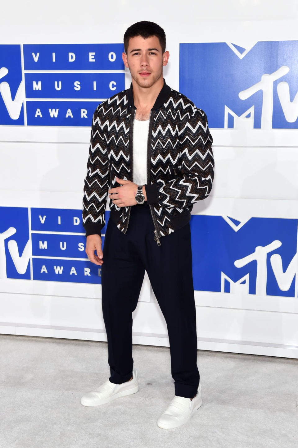 Nick Jonas wearing a zigzag bomber jacket from Louis Vuitton.