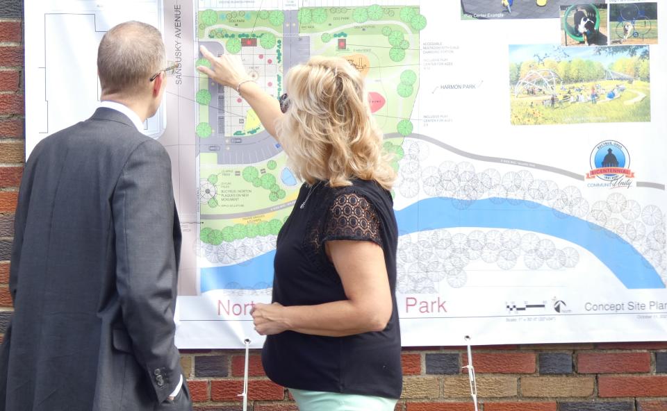 Kelli Patterson of the Bucyrus Bicentennial Commission, right, discusses plans for the Norton Bicentennial Park with David Zak of the Crawford Partnership on Monday morning in front of the old ice plant at 520 N. Sandusky Ave.