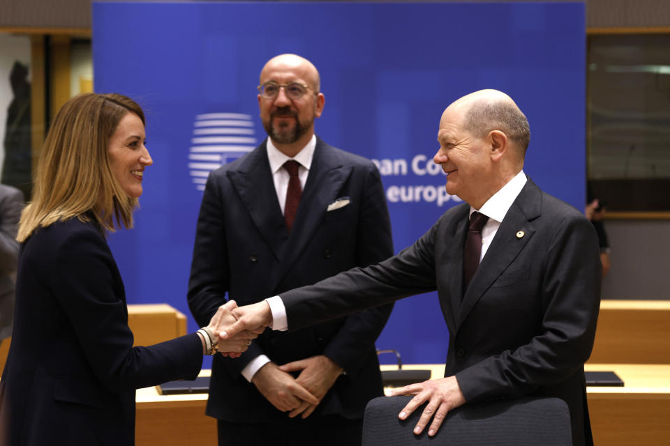 Germany's Chancellor Olaf Scholz, right, speaks with European Parliament President Roberta Metsola, left, and European Council President Charles Michel during a round table meeting at an EU summit in Brussels, Wednesday, April 17, 2024. European leaders' discussions at a summit in Brussels were set to focus on the bloc's competitiveness in the face of increased competition from the United States and China. Tensions in the Middle East and the ongoing war between Russia and Ukraine decided otherwise and the 27 leaders will dedicate Wednesday evening talks to foreign affairs. (AP Photo/Omar Havana)