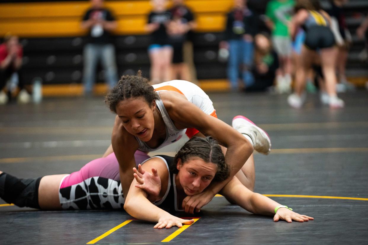 Amalia Djoumessi, top, of Waverly-Shell Rock wrestles Gwen Wright on Sunday at the State Freestyle Championships at Southeast Polk High School. Djoumessi won a 155-pound championship.