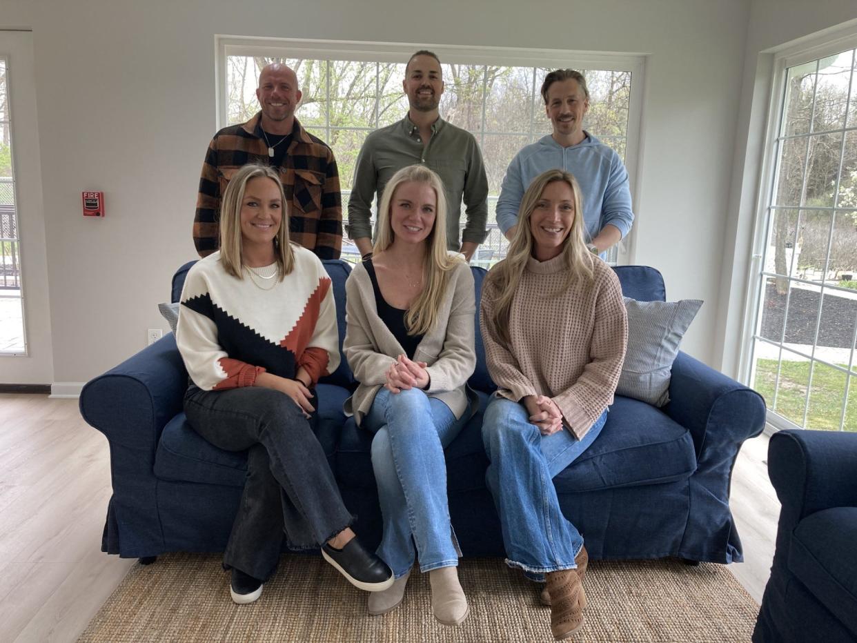 The owners of Oakbrook Senior Living pose for a photo with their wives. From left to right: Seth Michael (back left), Geoffrey Gane (back center), Douglas Kinney (back right), Hannah Michael (front left), Jenn Gane (front center) and Rachel Kinney (front right).