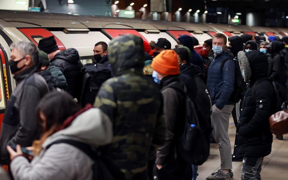 Commuters wait for the train at rush hour at Canning Town underground station in London - REUTERS/Hannah McKay