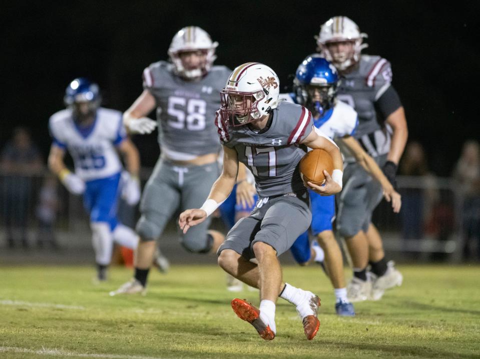 Quarterback Wyatt Scruggs (17) keeps the ball during the Jay vs Northview football game at Northview High School in Century on Friday, Oct. 13, 2023.