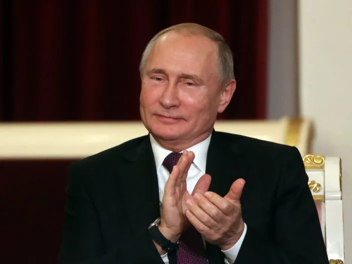 Russian President Vladimir Putin clapping.