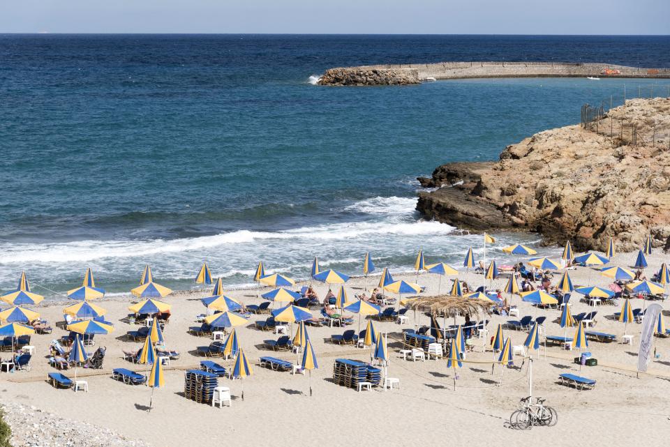 Beach and sunshades on the Cretan seaside resort of Sisi close to Malia, Crete, Greece. (Photo by: Education Images/Universal Images Group via Getty Images)