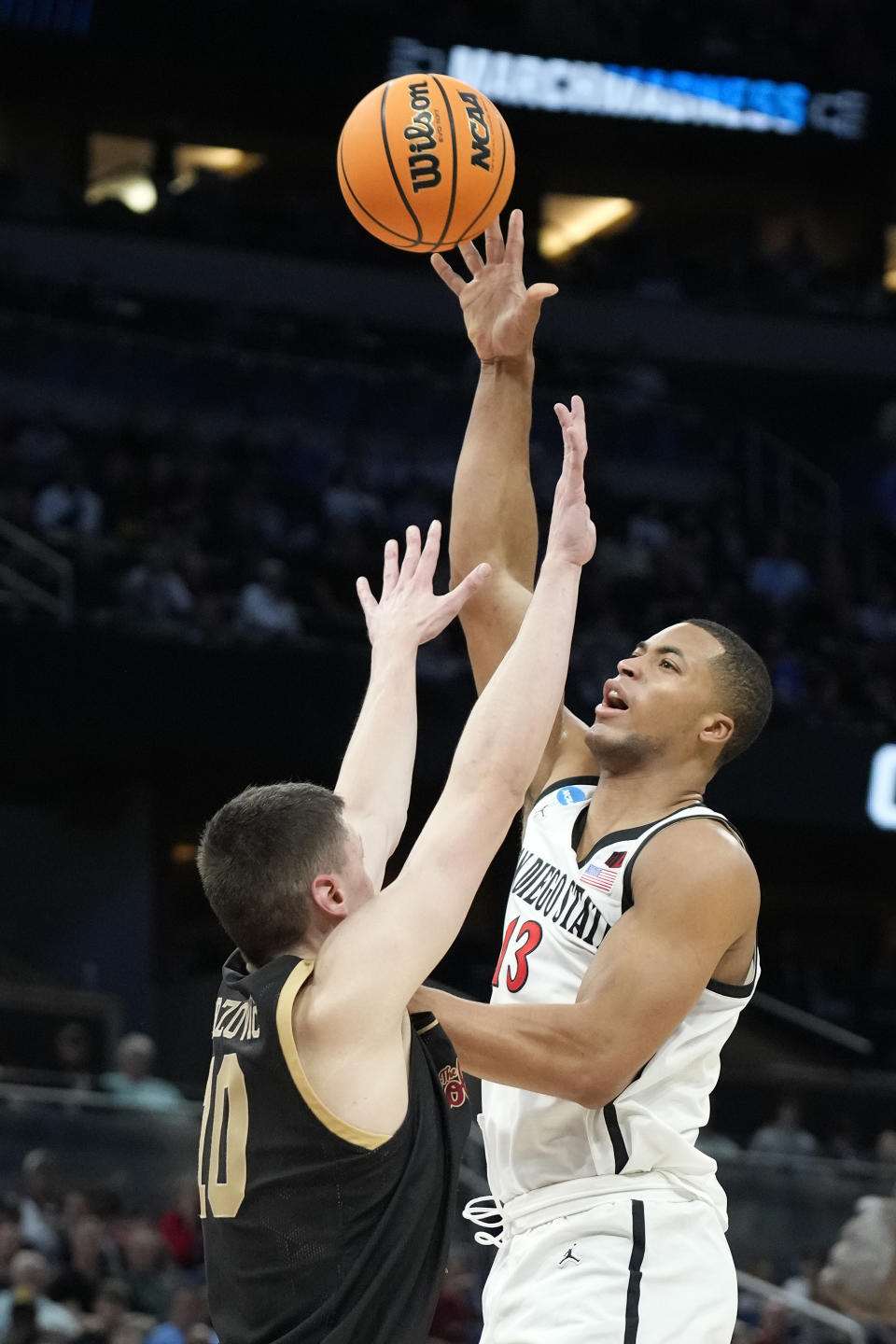 San Diego State forward Jaedon LeDee (13) shoots over Charleston forward Ante Brzovic (10) during the first half of a first-round college basketball game in the NCAA Tournament Thursday, March 16, 2023, in Orlando, Fla. (AP Photo/Chris O'Meara)