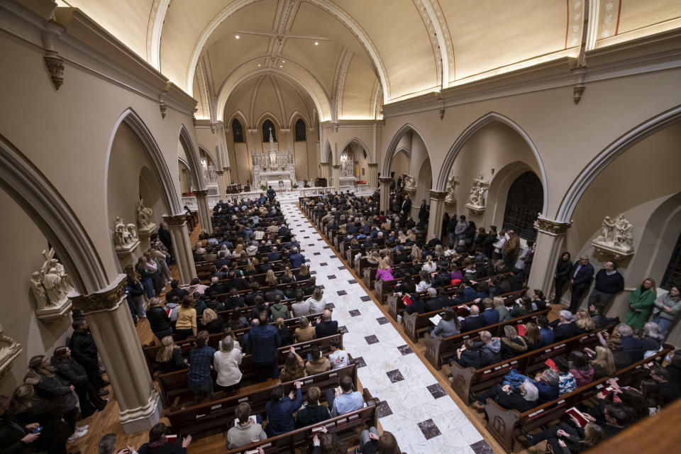 A memorial service is held for Brian Fraser at St. Paul on the Lake Catholic Church in Grosse Pointe Farms, Mich., on Tuesday, Feb. 14, 2023. Fraser was identified as one of the students slain during a mass shooting on Michigan State University's campus the night before. (David Guralnick/Detroit News via AP, Pool)