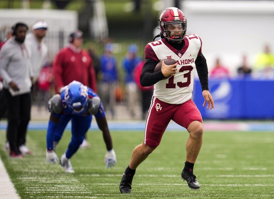 Oklahoma Sooners quarterback Caleb Williams runs against the Kansas Jayhawks during the first half at David Booth Kansas Memorial Stadium.