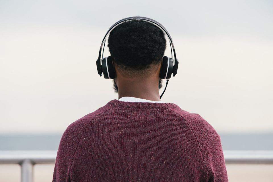 A man outside with headphones.