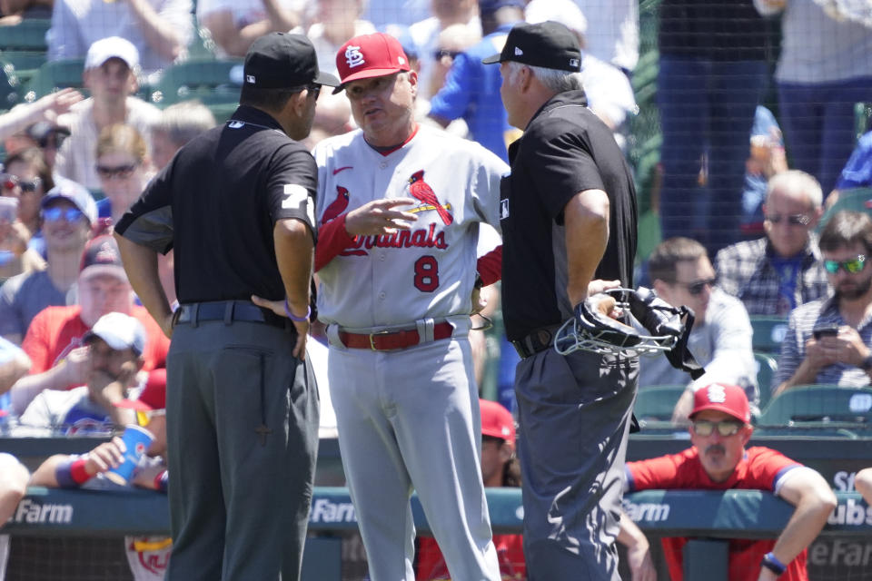 St. Louis Cardinals manager Mike Shildt (8) discusses a call with the umpires during the first inning of a baseball game against the Chicago Cubs, Friday, July 9, 2021, in Chicago. (AP Photo/David Banks)