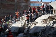 Search and rescue teams work on a collapsed building after an earthquake in Elazig