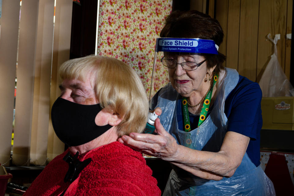 Margaret Sherlock, 91 cuts the hair of Cath Murphy a regular customer. (SWNS)