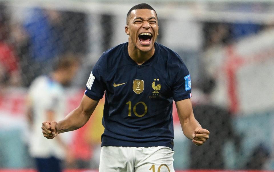 France's Kylian Mbappe laughs after missing England's Harry Kane penalty kick - REUTERS