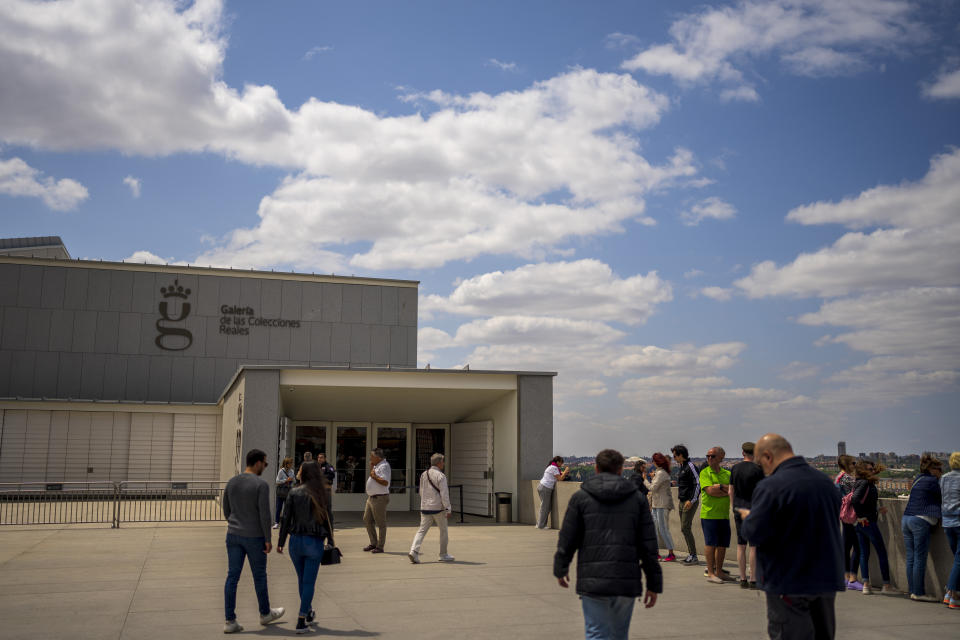 People walk around the main entrance of the Royal Collections Gallery in Madrid, Spain, Friday, May. 19, 2023. Spain is set to unveil what is certain be one of Europe's cultural highlights this year with the opening in Madrid of The Royal Collections Gallery next month. (AP Photo/Manu Fernandez)