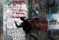 <p>An Israeli border police officer throws a sound grenade toward Palestinian demonstrators in Bethlehem in the occupied West Bank during a protest against the U.S. Embassy’s move to Jerusalem on May 14, 2018. (Photo: Mussa Qawasma/Reuters) </p>