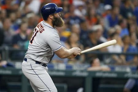 Jul 31, 2018; Seattle, WA, USA; Houston Astros designated hitter Evan Gattis (11) hits a two-run homer against the Seattle Mariners during the sixth inning at Safeco Field. Mandatory Credit: Joe Nicholson-USA TODAY Sports