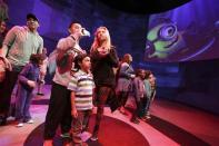 People watch video screens at the new "Despicable Me Minion Mayhem" ride during technical rehearsals for the new attraction at Universal Studios Hollywood in Universal City, California March 28, 2014. REUTERS/Jonathan Alcorn